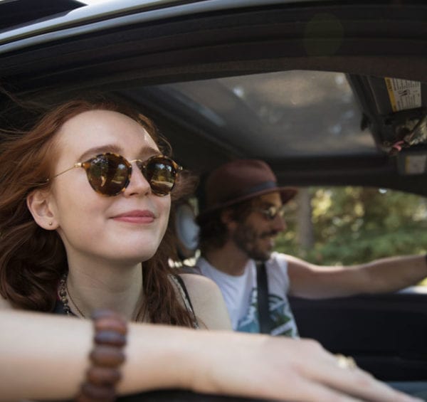 two people in car wearing sunglasses