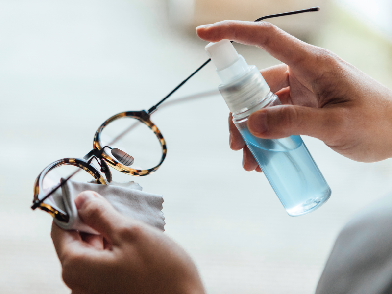 cleaning glasses with spray and cloth